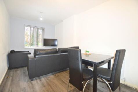 A contemporary living room featuring black leat...
