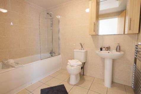 A bright and clean large bathroom featuring a b...