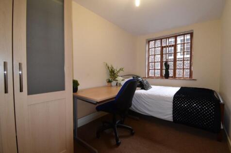 Cozy single bedroom featuring a comfortable sin...