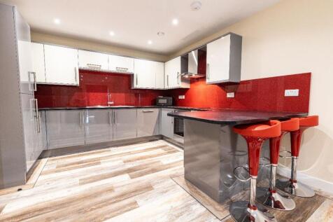 Modern kitchen with glossy cabinets, vibrant re...