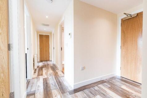 Bright and clean hallway featuring stylish wood...