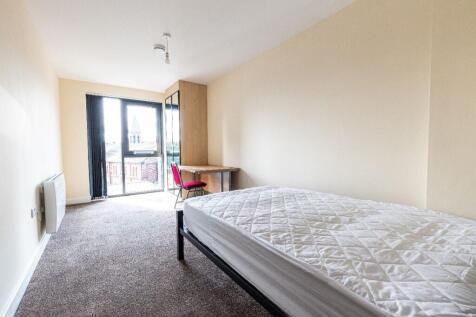 A clean and bright single bedroom featuring a c...