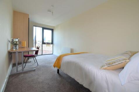 A bright and tidy double bedroom with a desk, p...