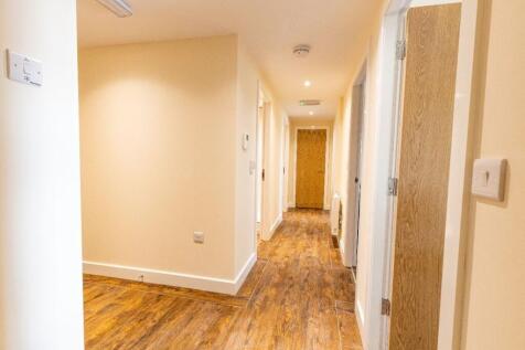 A clean and well-maintained hallway featuring w...