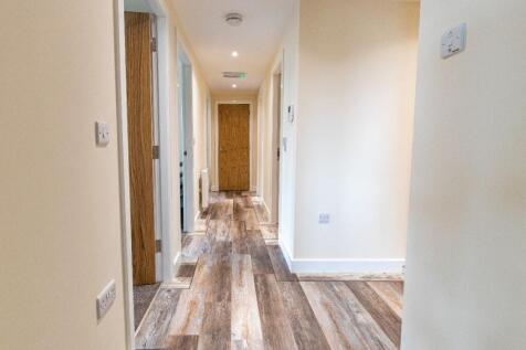 Bright and clean hallway with modern wood-effec...