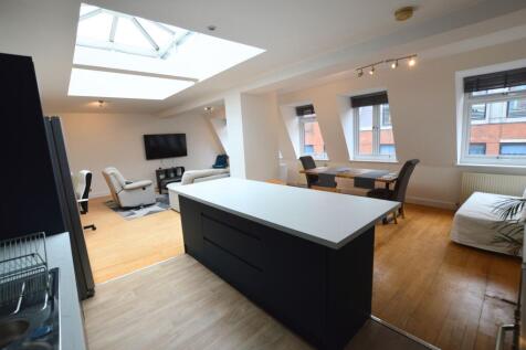A spacious and modern living area featuring a s...
