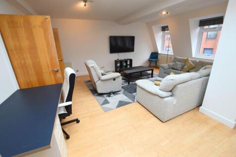 A stylish and spacious living room featuring co...