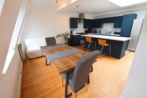 Bright and modern kitchen featuring deep blue c...