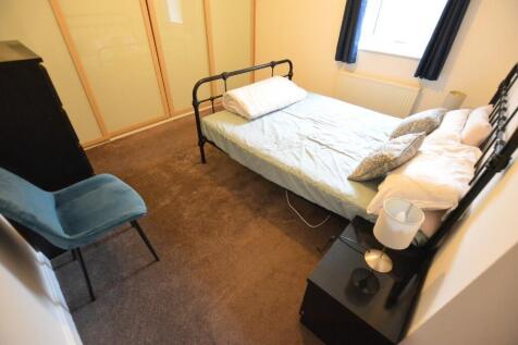 A cozy double bedroom featuring a sturdy metal ...