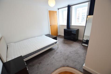 A neat and bright single bedroom featuring a co...