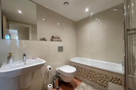 A modern and well-maintained bathroom suite fea...