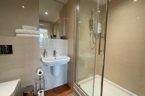 A modern and well-maintained bathroom suite fea...