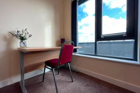 A bright and tidy communal workspace featuring ...