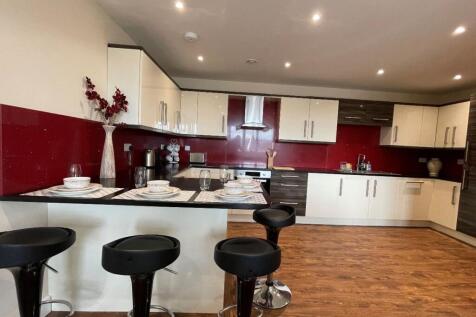 Bright, modern kitchen featuring a spacious bre...