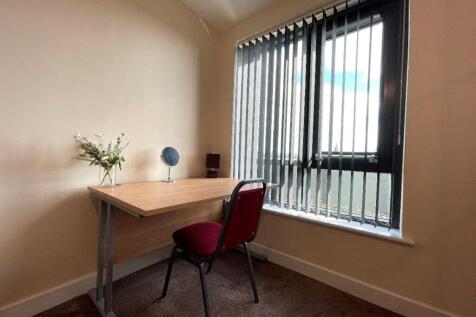 Bright and tidy workspace featuring a simple de...