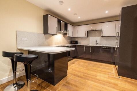 A modern kitchen featuring sleek black cabinetr...