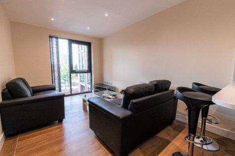 A modern living room featuring comfortable blac...