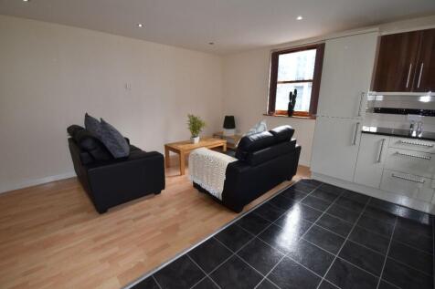 A modern living room with comfortable black sof...