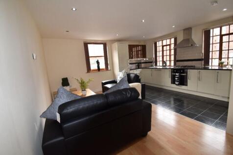 A modern open-plan living room and kitchen area...