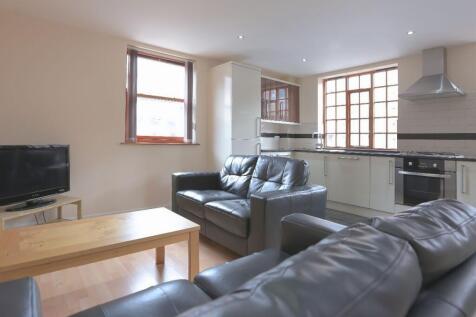 A bright and modern living room featuring comfo...