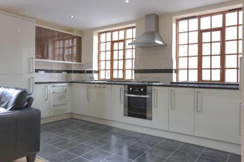 Bright and modern kitchen featuring ample natur...