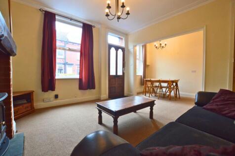 A warm and inviting living room featuring a coz...