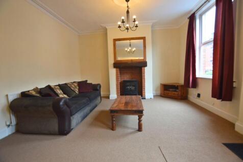 A cozy living room featuring a comfortable dark...