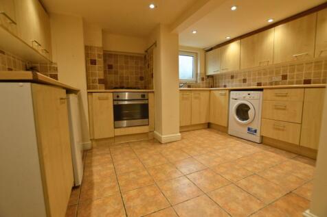 Bright and tidy kitchen featuring ample wooden ...