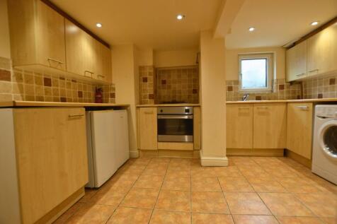 A well-maintained kitchen featuring light wood ...