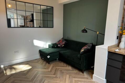 A modern living room featuring a stylish dark g...
