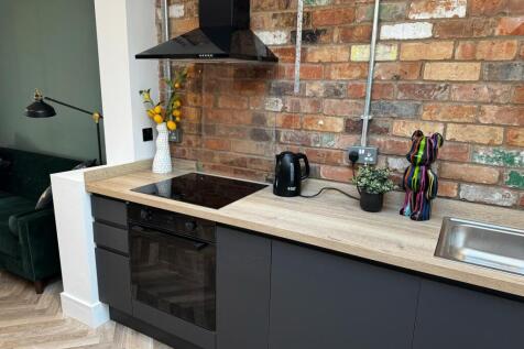 Modern kitchen featuring a sleek electric hob a...