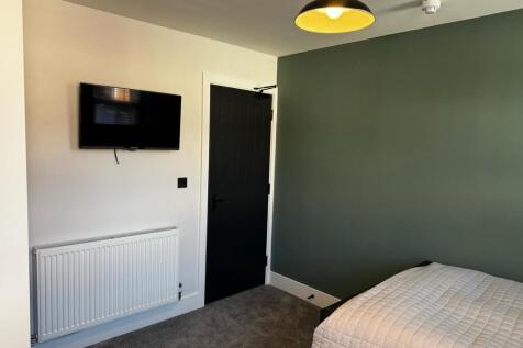 A modern double bedroom featuring a comfortable...
