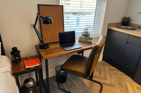 A cosy student bedroom corner featuring a styli...