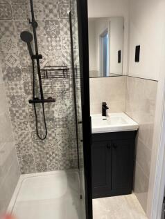 A modern bathroom featuring a stylish patterned...