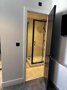 A modern bathroom featuring a stylish walk-in s...