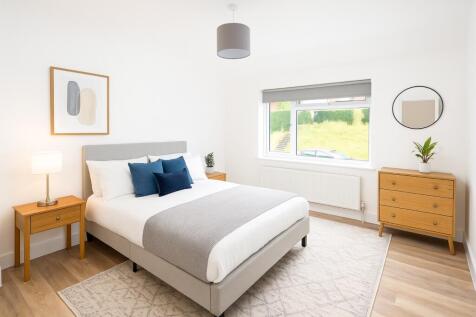 Bright and spacious master bedroom featuring a ...