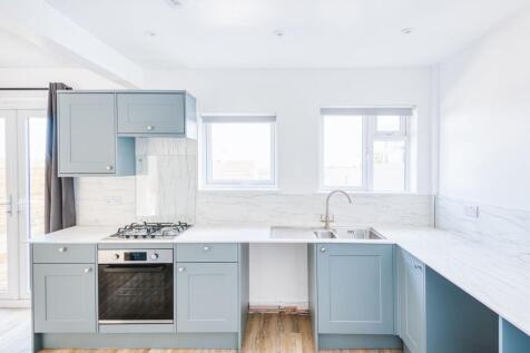 Bright and modern kitchen featuring soft blue c...