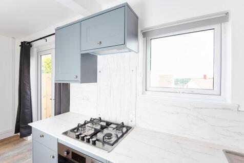 Bright and modern kitchen featuring a sleek gas...