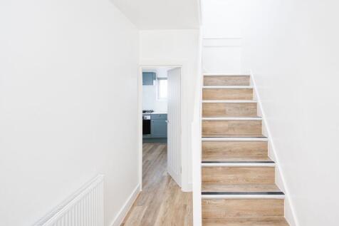 Bright and clean hallway featuring modern woode...