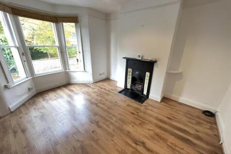 Spacious and bright living room featuring a lar...