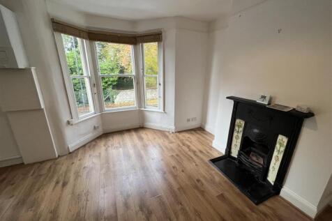 Bright living room featuring large bay windows ...