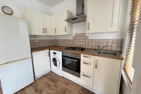 Bright and tidy kitchen featuring modern applia...