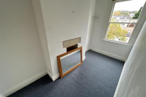 A compact bedroom with a large window allowing ...
