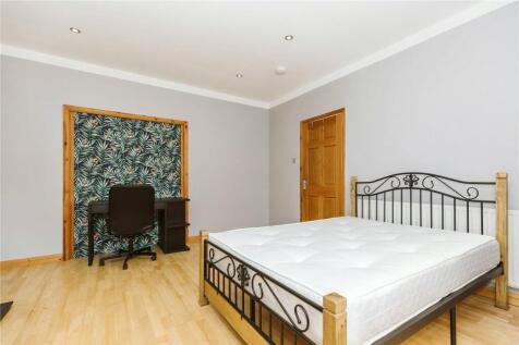 Bright and spacious master bedroom featuring a ...