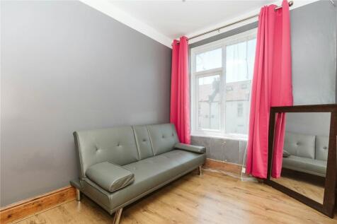 A bright living room featuring a large window w...