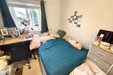 Cozy double bedroom featuring a large bed and a...