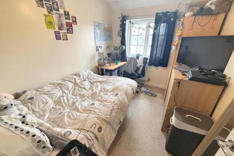 This cozy double bedroom features a comfortable...