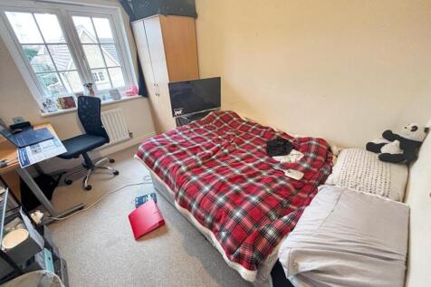Cozy double bedroom featuring a comfortable bed...
