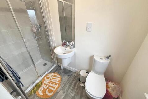 Modern bathroom featuring a spacious shower, sl...