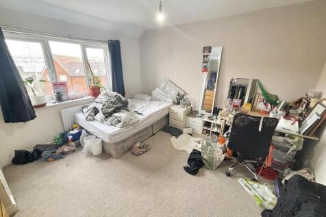 Spacious double bedroom featuring large windows...